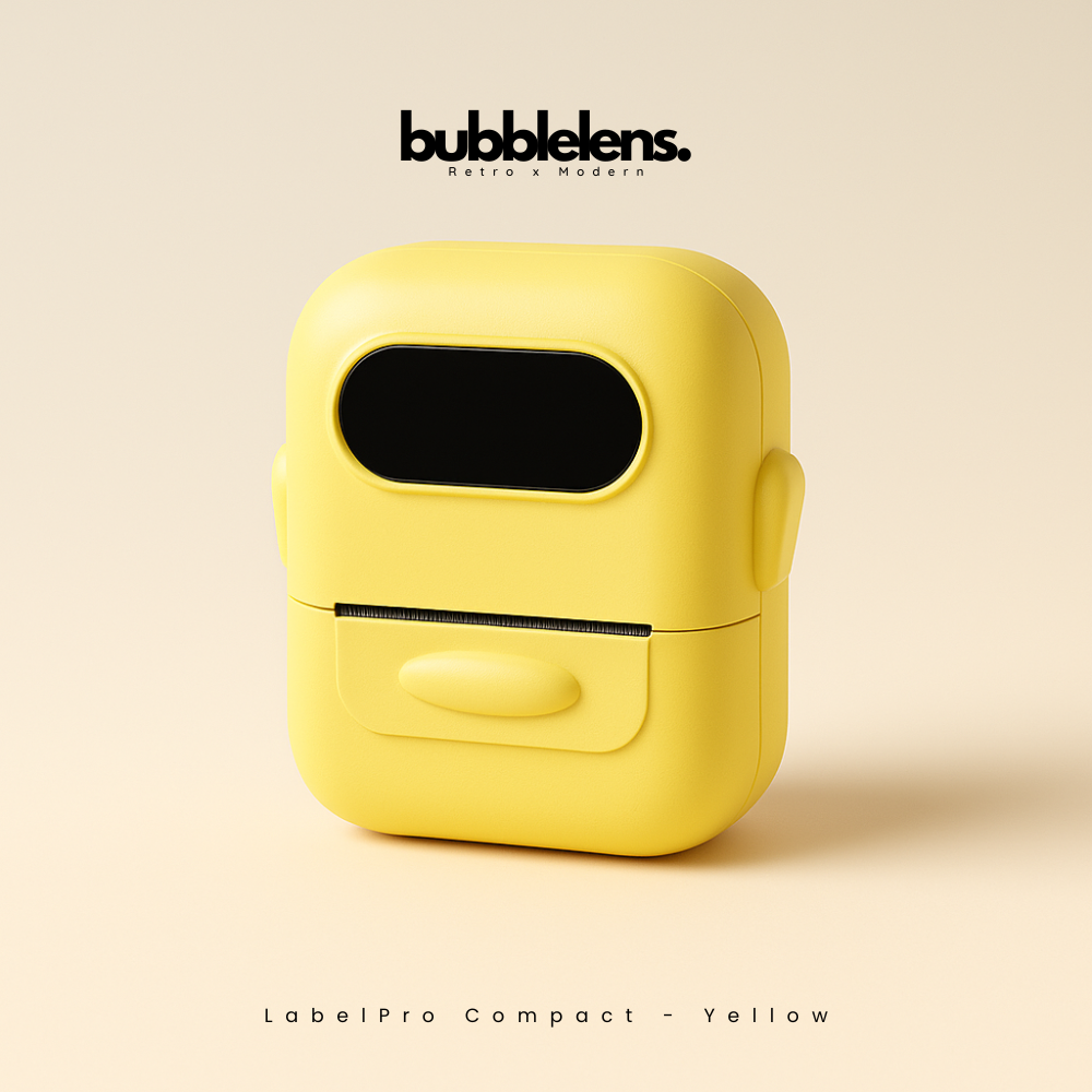 Yellow label printer with 'bubble lens' branding on a beige background