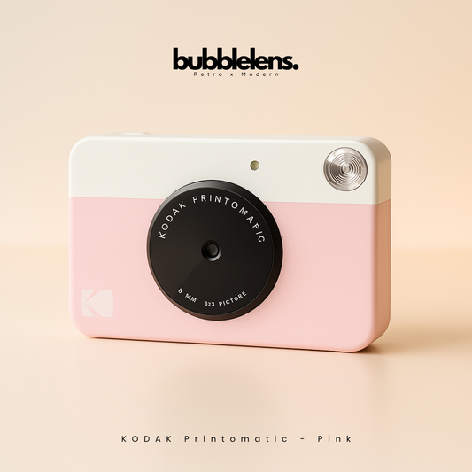 Pink Kodak Printomatic camera with 'bubblelens' branding on a beige background