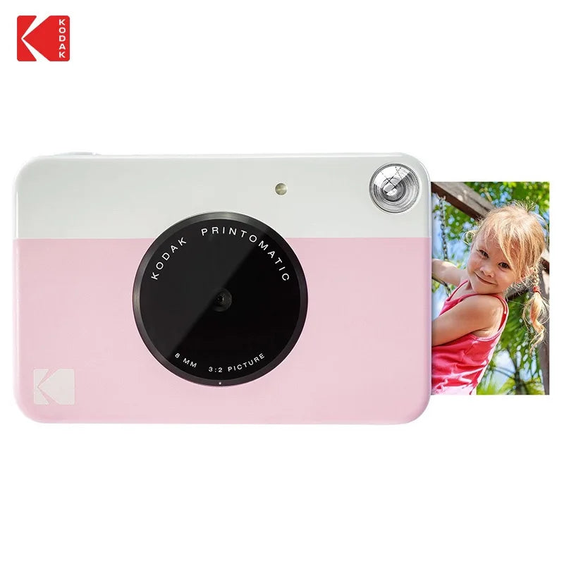 Pink and white Kodak Printomatic camera with a photo of a child on a white background