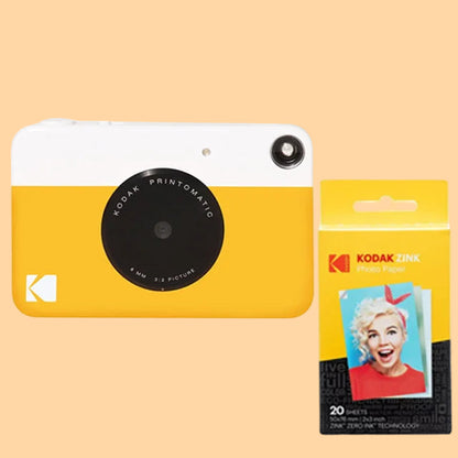 Yellow Kodak camera and photo paper package on a white background