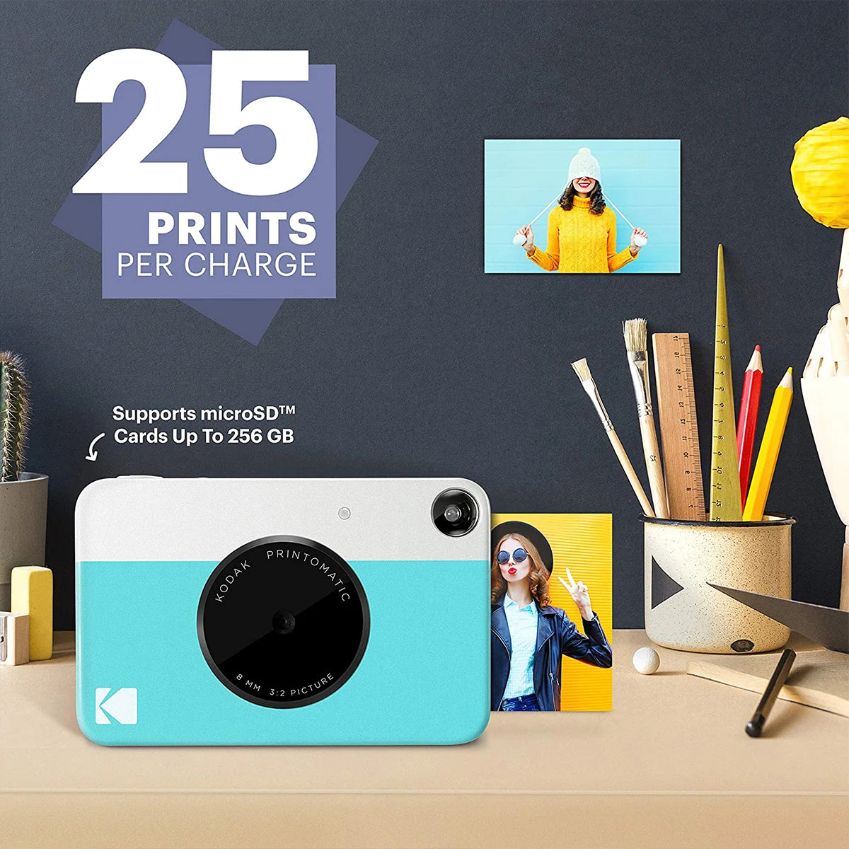 Kodak Printomatic camera with printed photos on a desk, promotional text about print capacity and microSD card support.